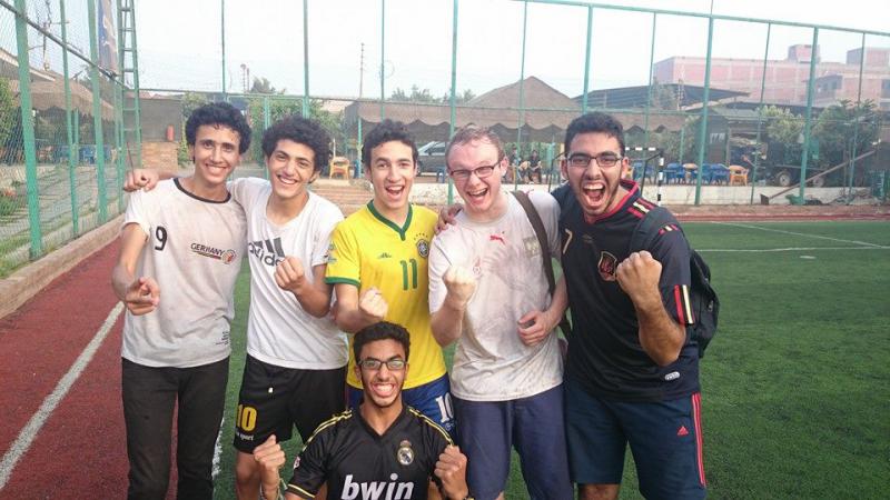 Six men posing for the camera raising their fists